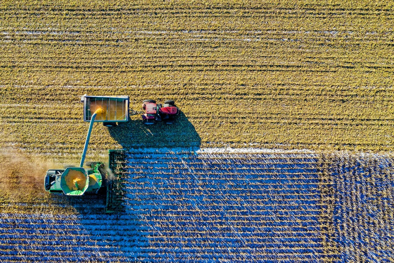 Aerial view of farm equipment harvesting a field