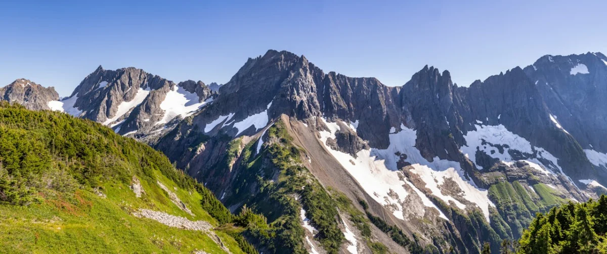 Rocky mountain ridge with patches of snow